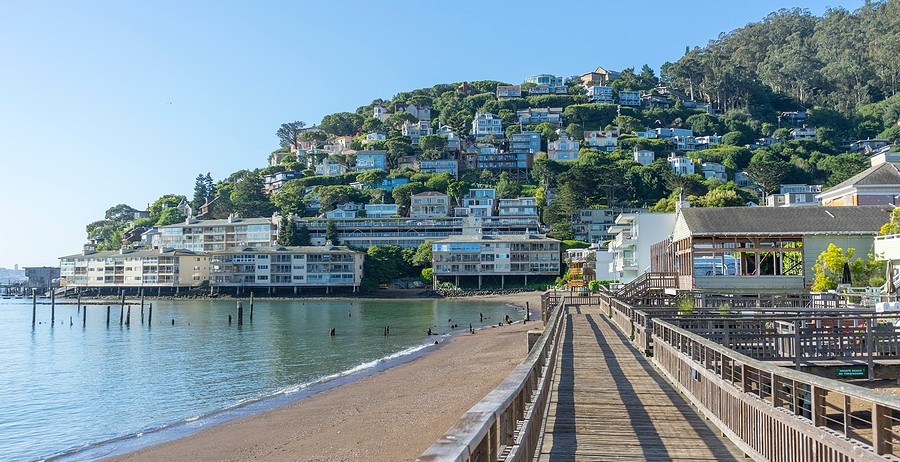 Wooden pier of Sausalito, CA with hillside homes in the background